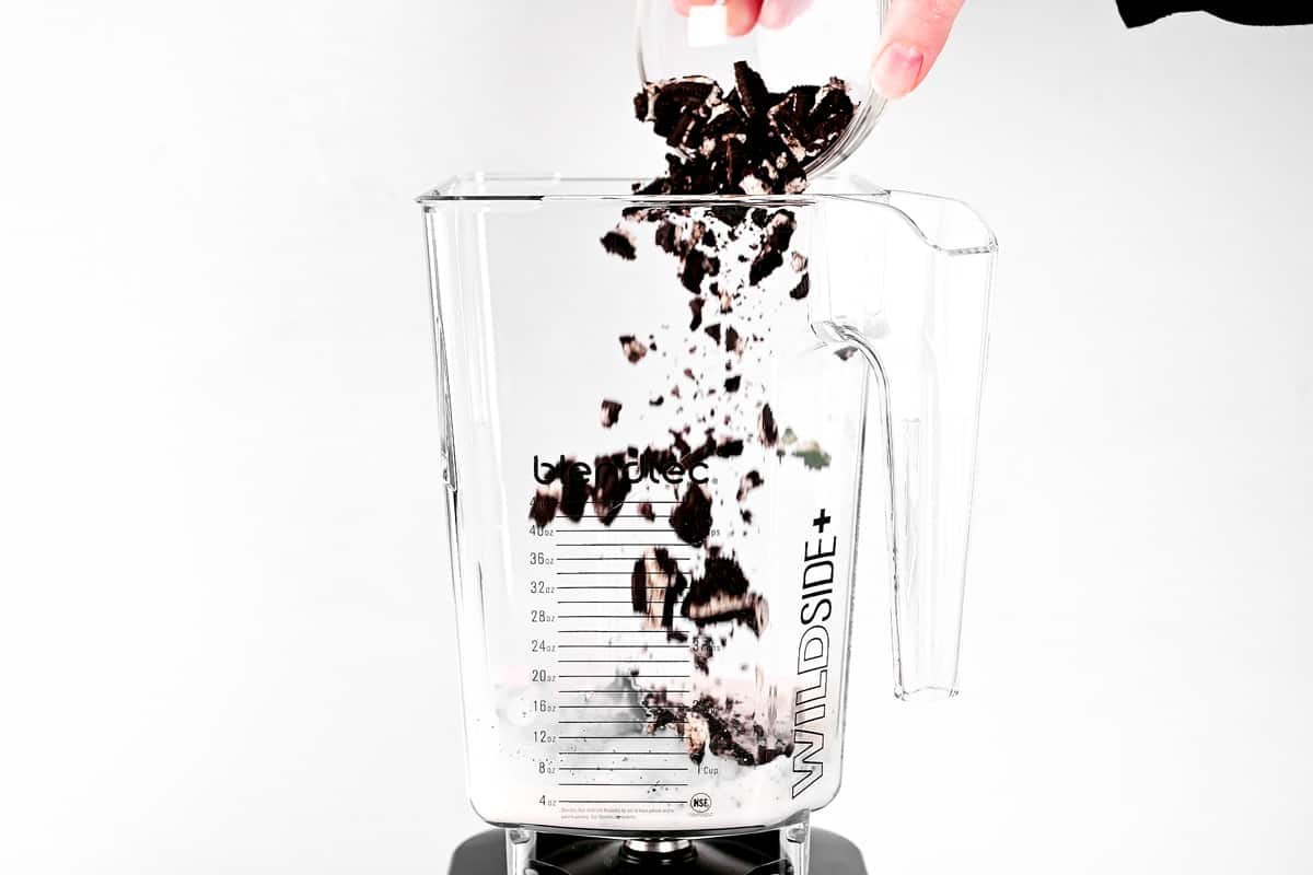 Pouring ingredients into the blender.