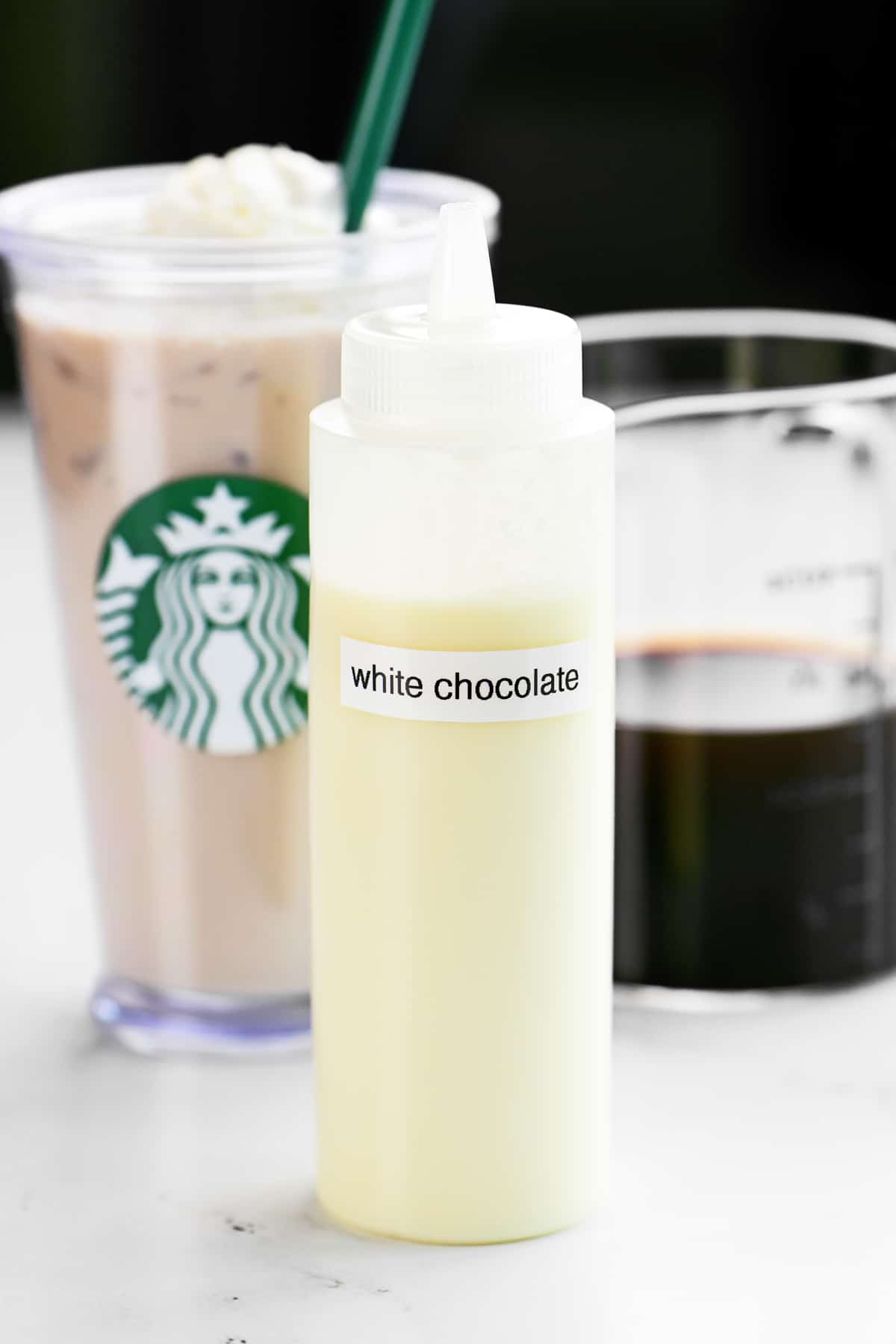 White chocolate sauce with a Starbucks cup and iced coffee.