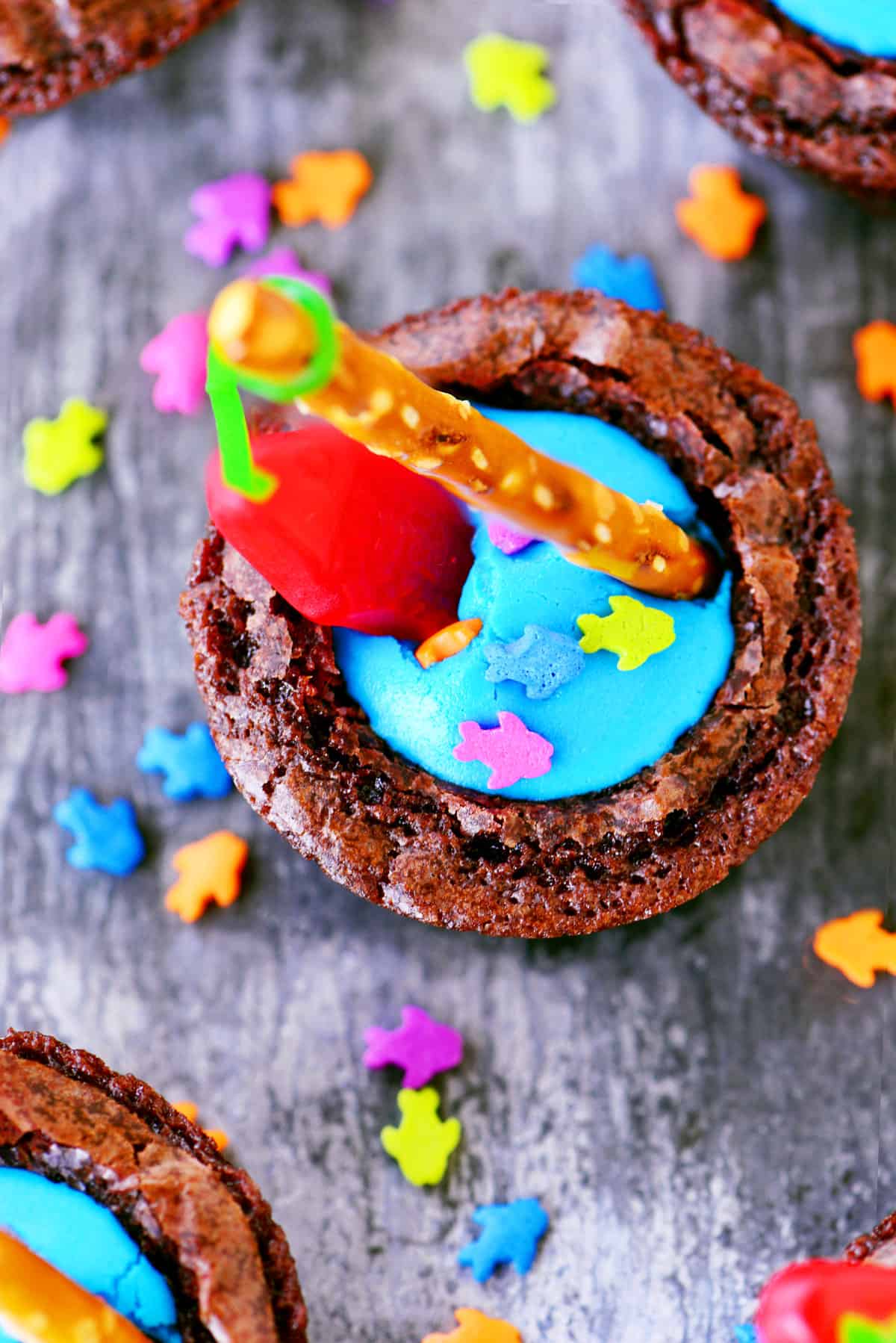 Brownie bites with frosting and gummy fish.