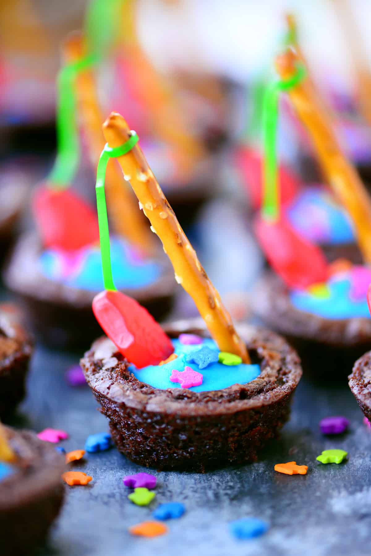 Brownie bites with frosting and gummy fish.