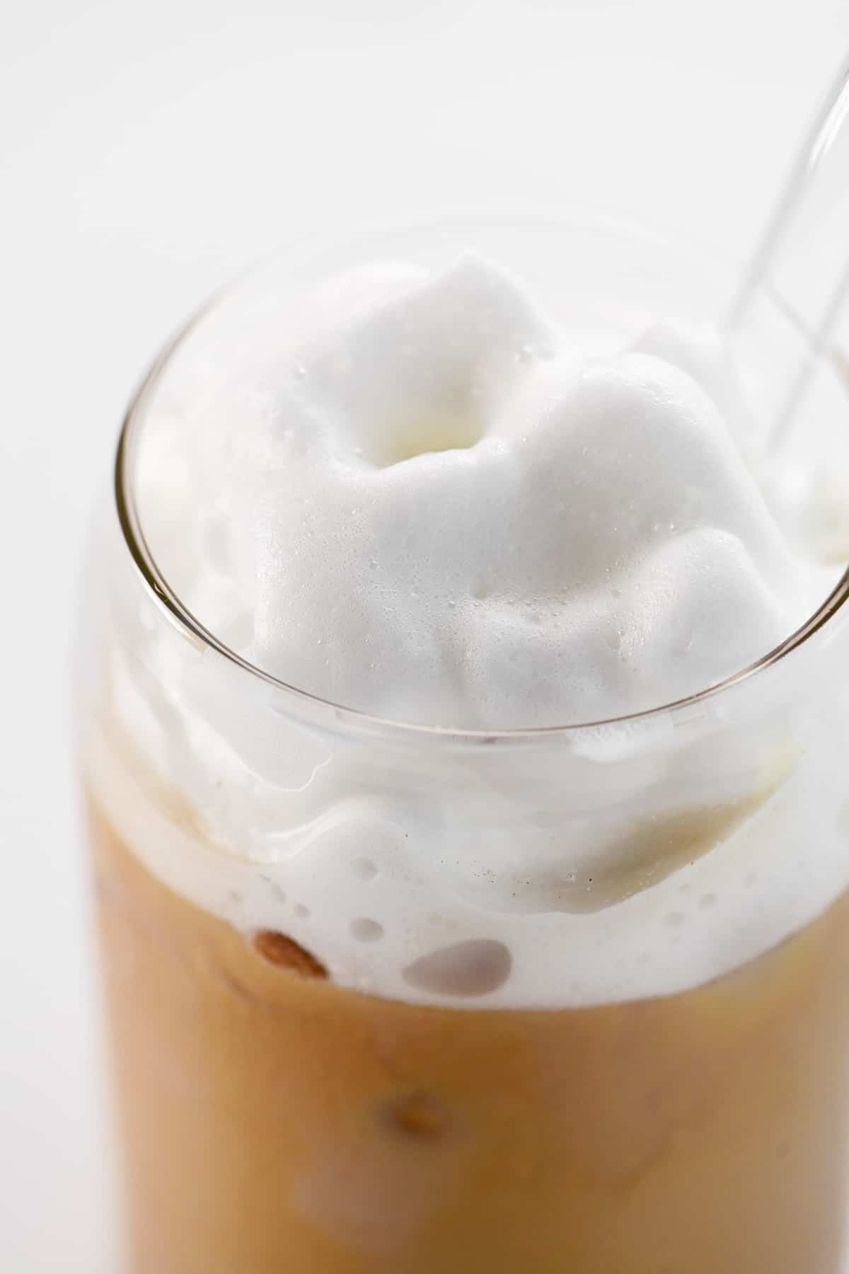 Cold foam on a cup of iced coffee.