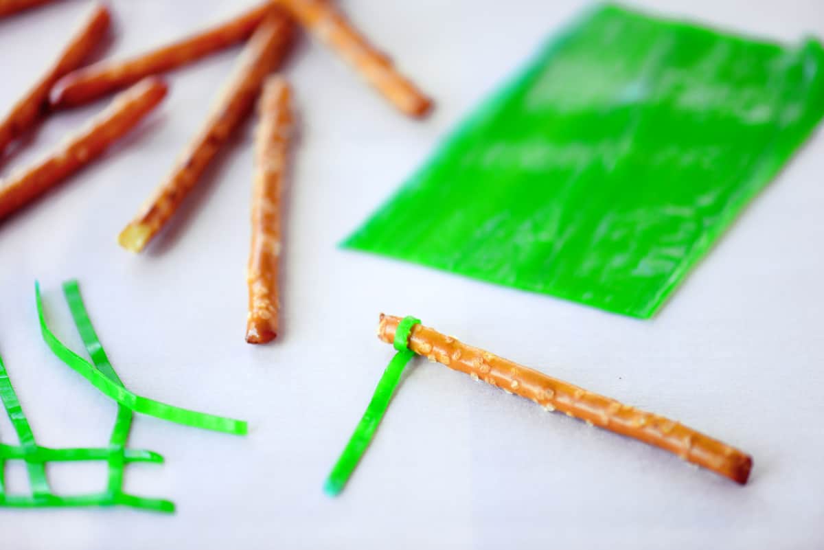 Wrapping a fruit roll up around a pretzel stick.