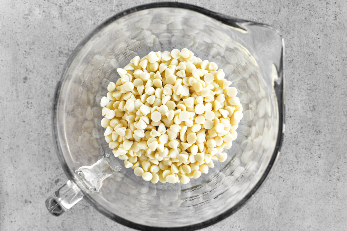 White chocolate chips in a glass mixing bowl.