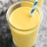 A mango smoothie in a glass.