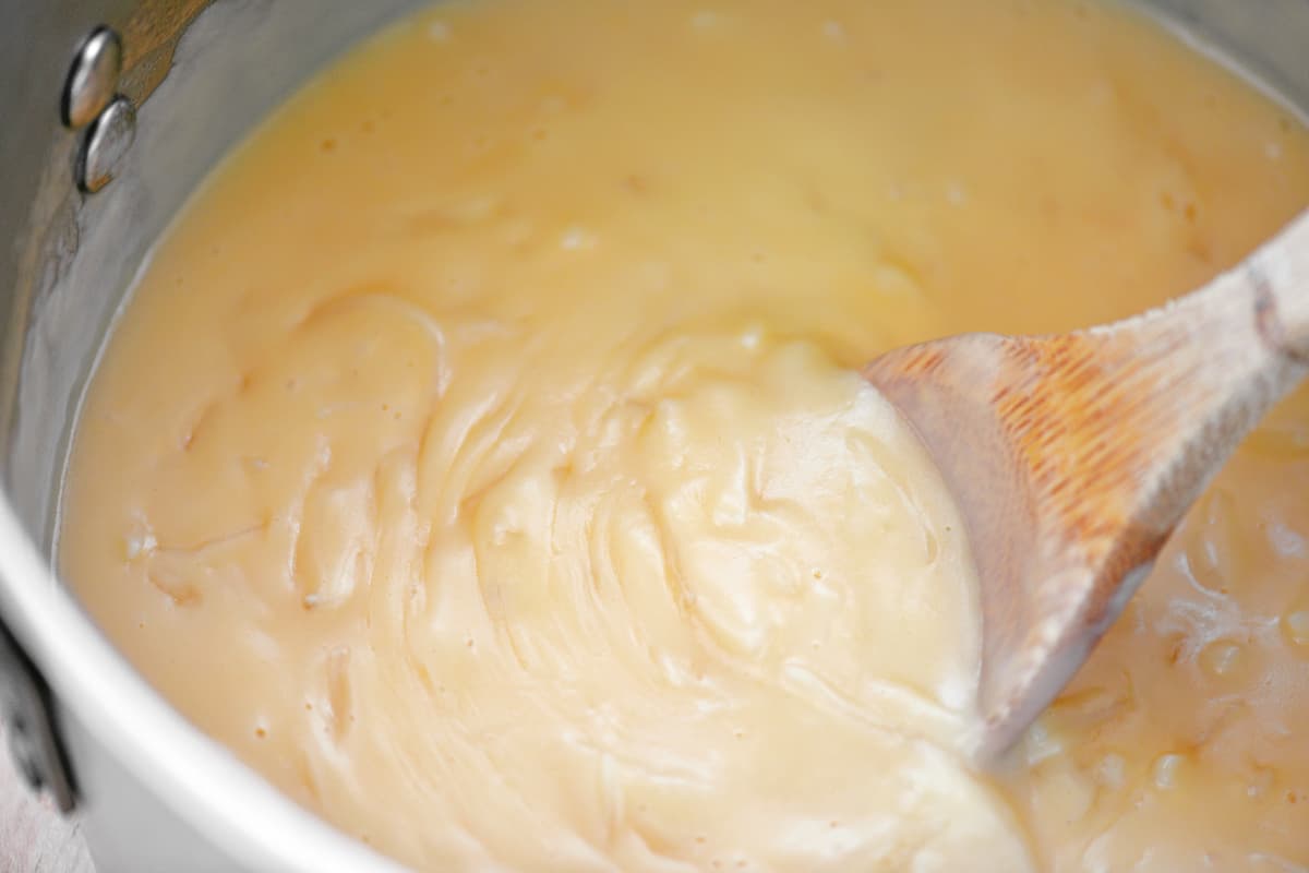 Stirring sauce in pot.