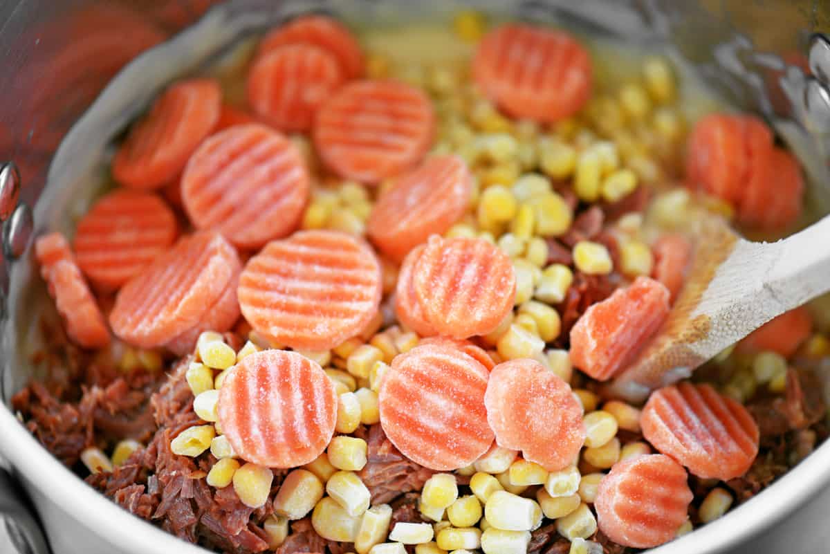 Add carrots and corn to the pot.