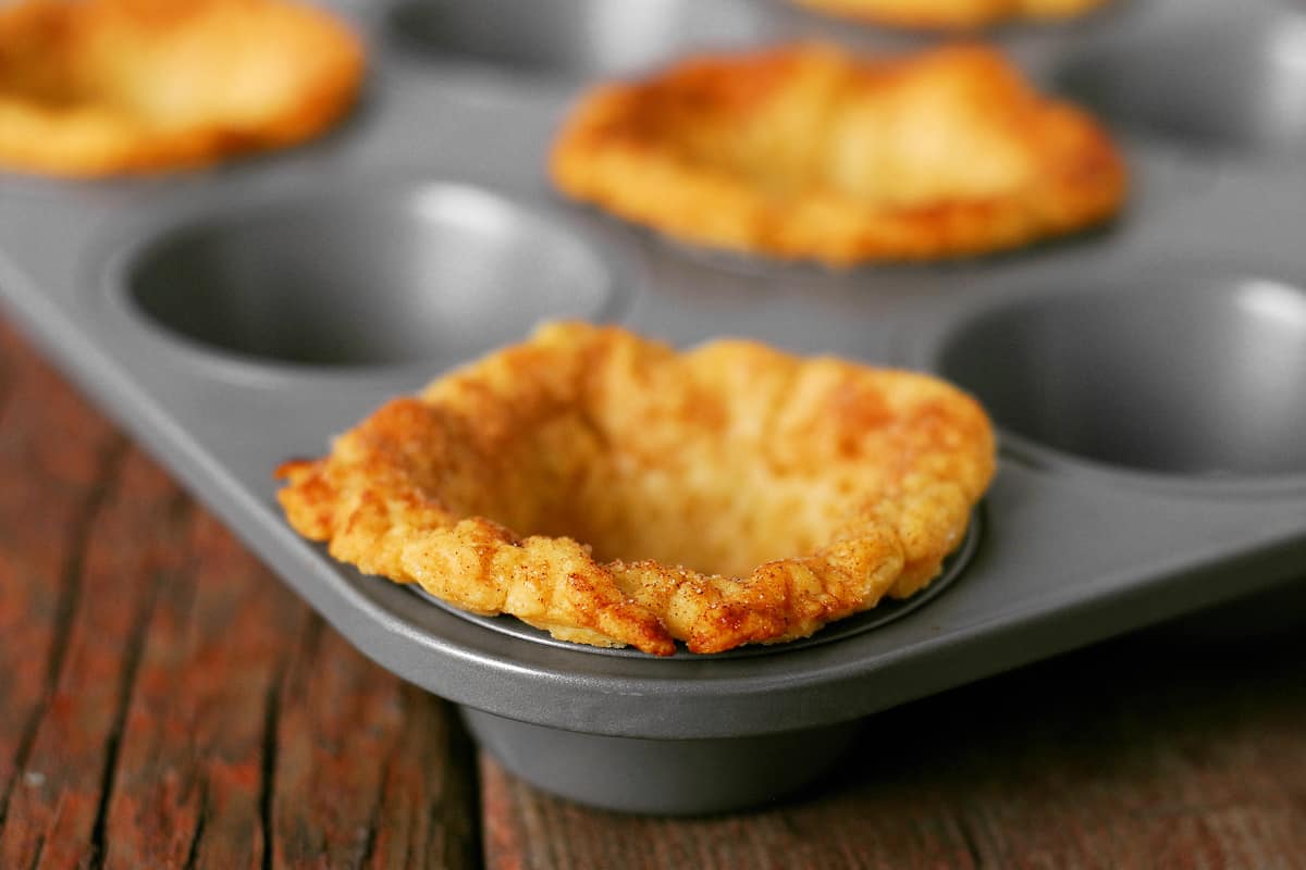 Mini pie crusts in a muffin pan.