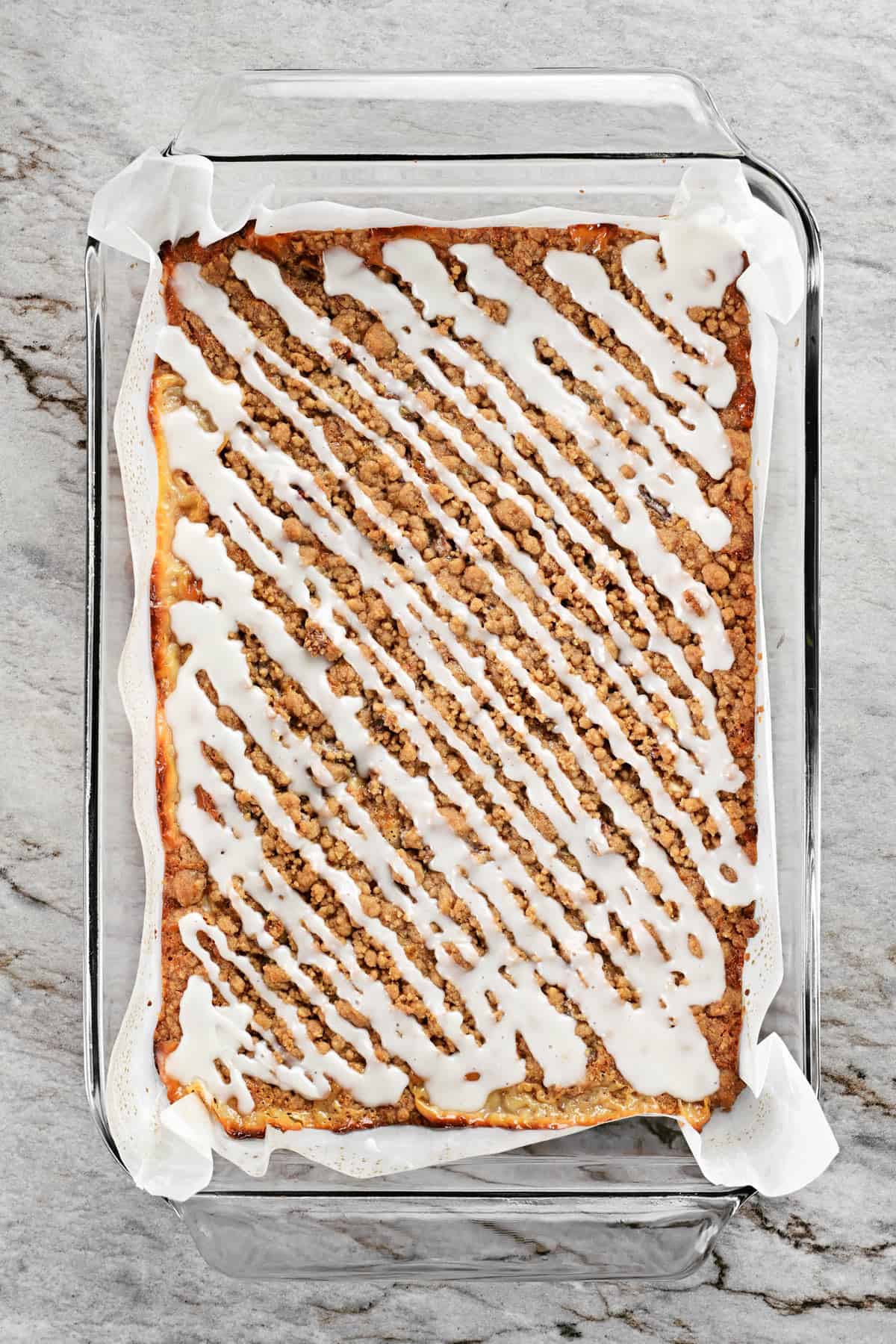 Apple bars in a pan with icing.