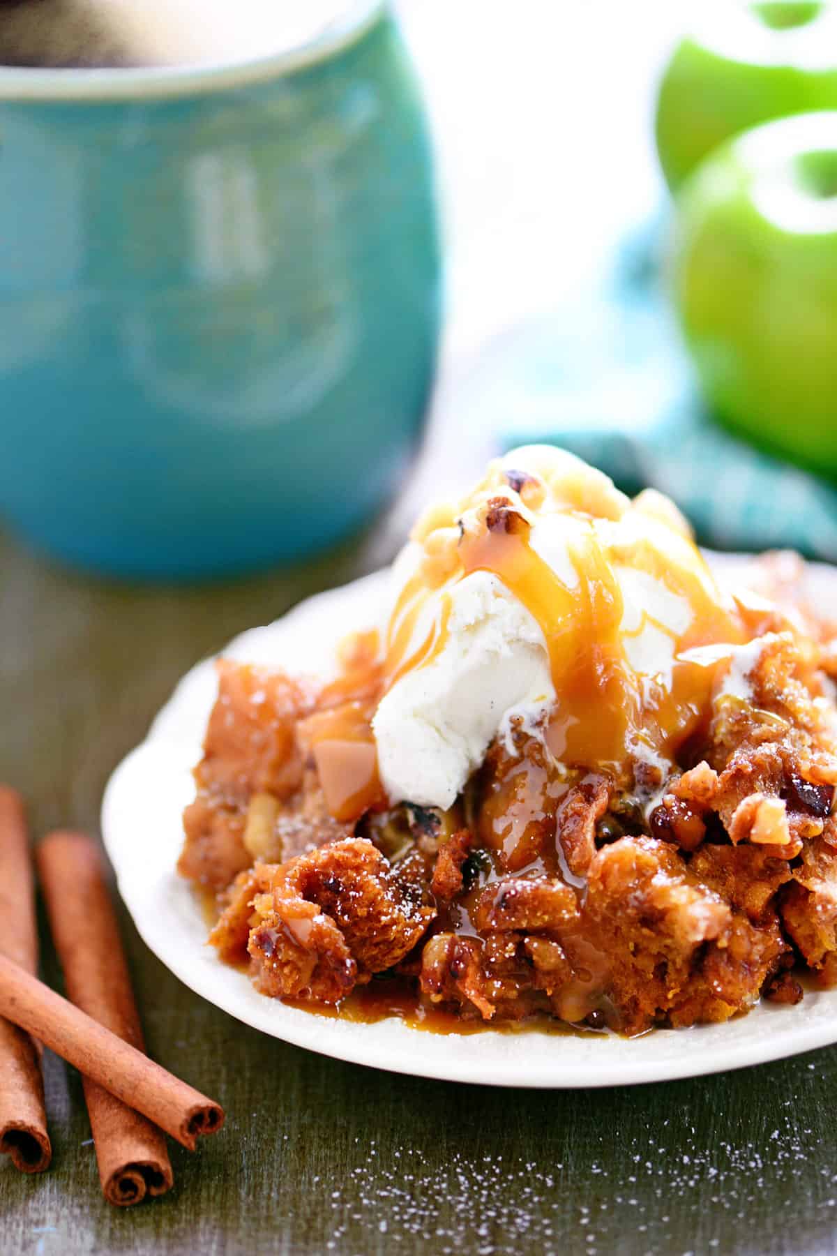 Apple bread pudding with ice cream and caramel on top.