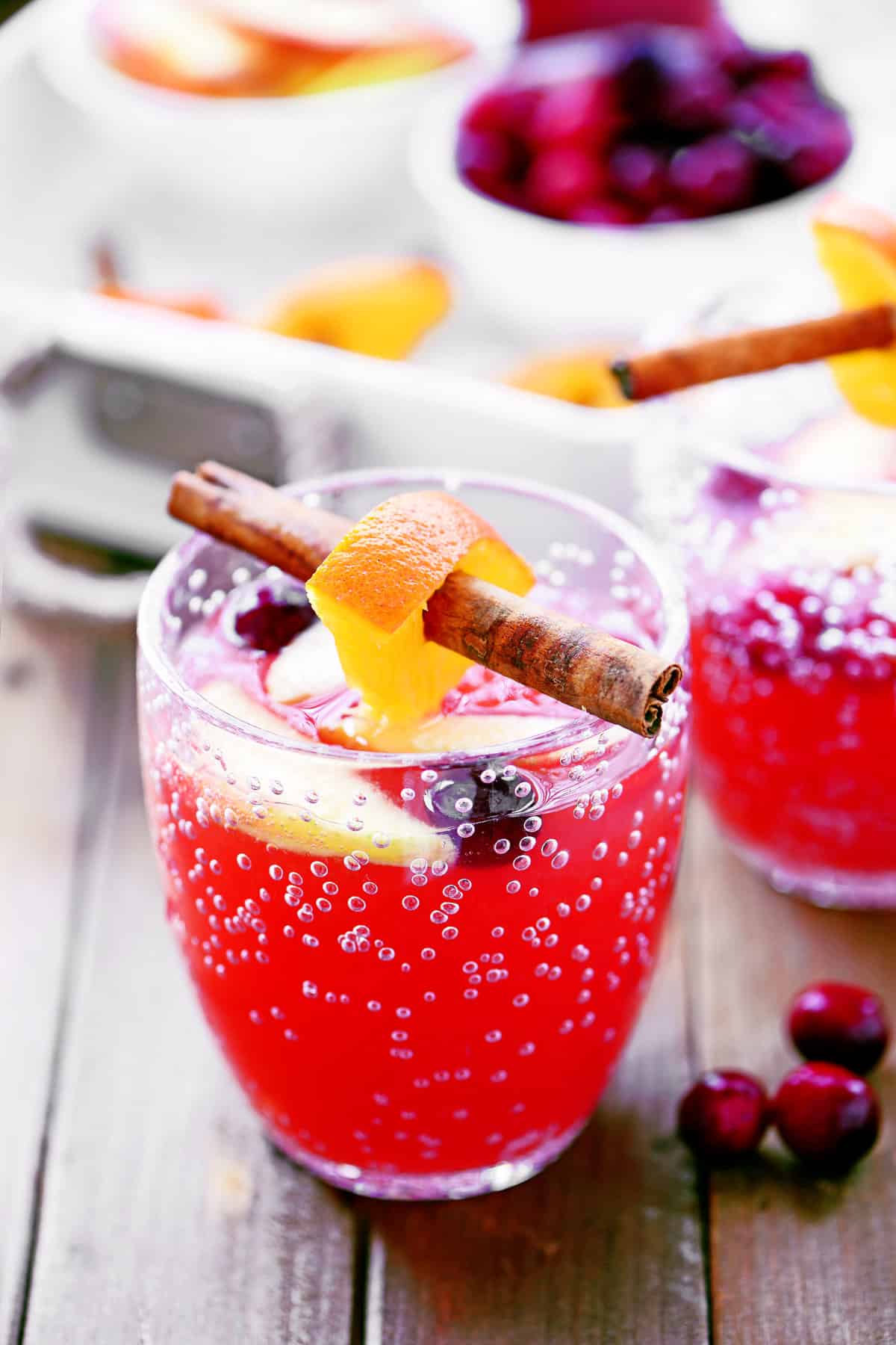 A cup with cranberry orange holiday punch inside.