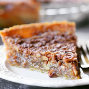 A slice of pecan pie without corn syrup on a white place.