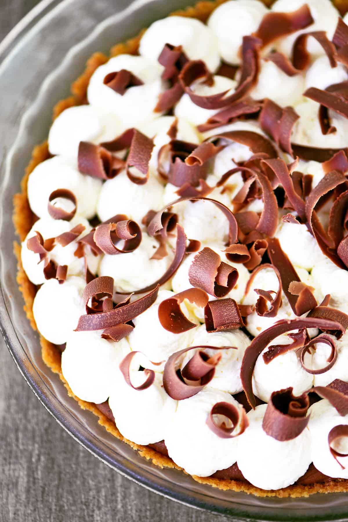 A french silk pie with whipped cream and chocolate curls.
