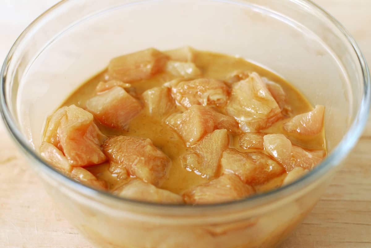 Marinating chicken in a glass bowl.