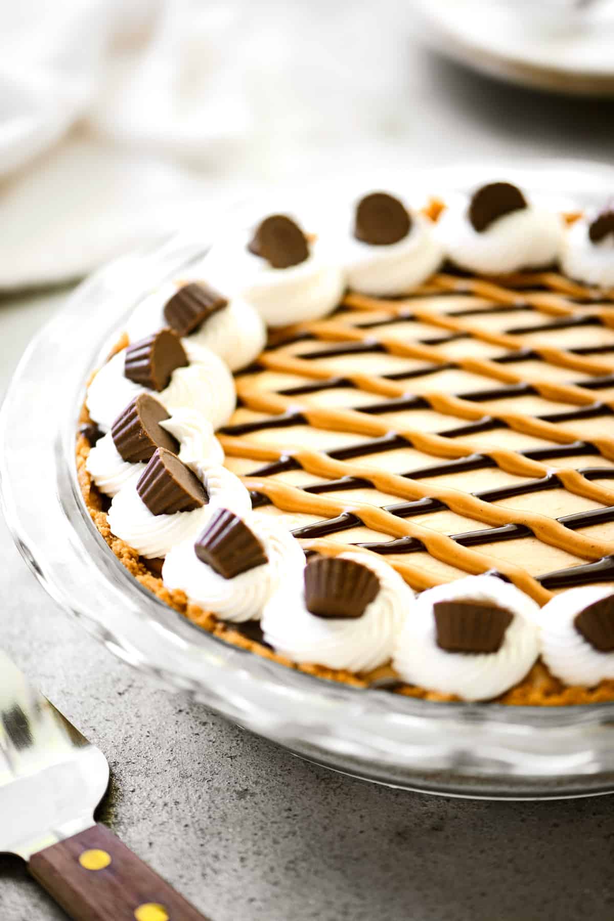 Oreo peanut butter pie with mini peanut butter cups on top.