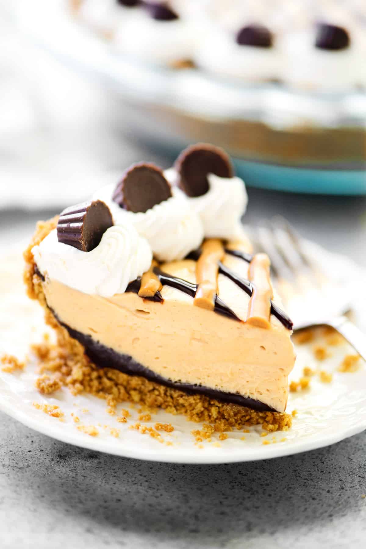 A slice of Oreo peanut butter pie on a white plate.