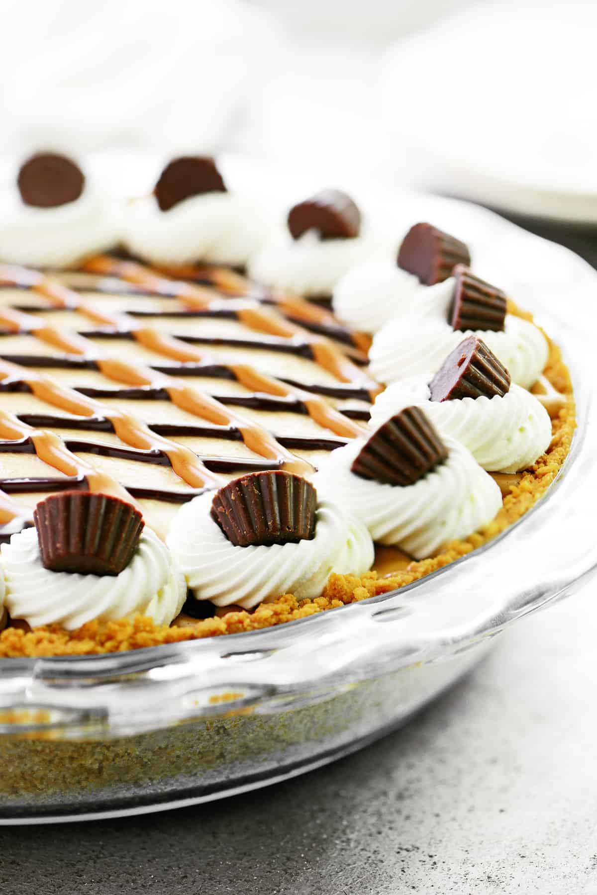 No bake Oreo peanut butter pie with whipped cream on top.