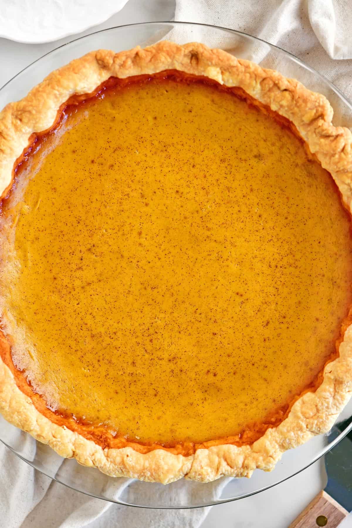 A baked pumpkin pie with sweetened condensed milk.