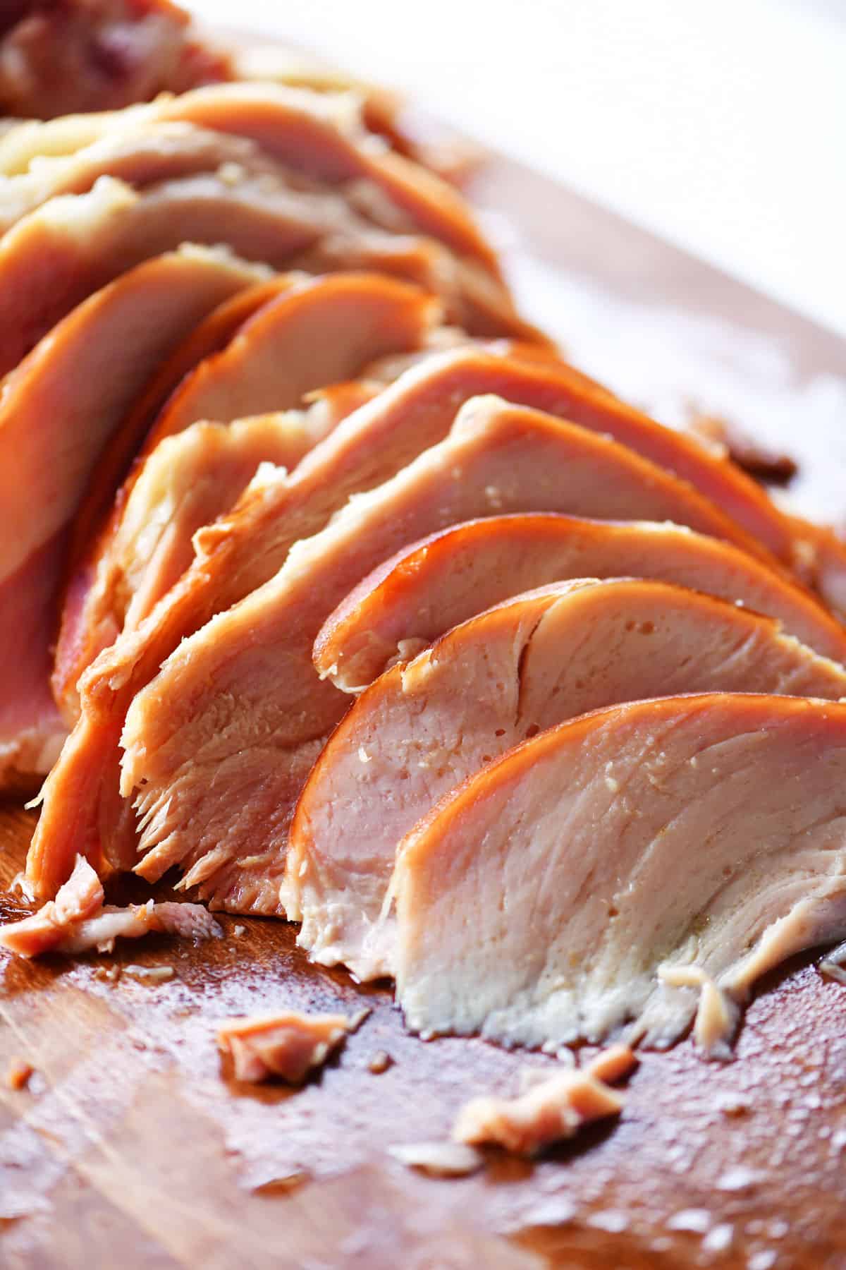 Plain sliced ham on a cutting board.