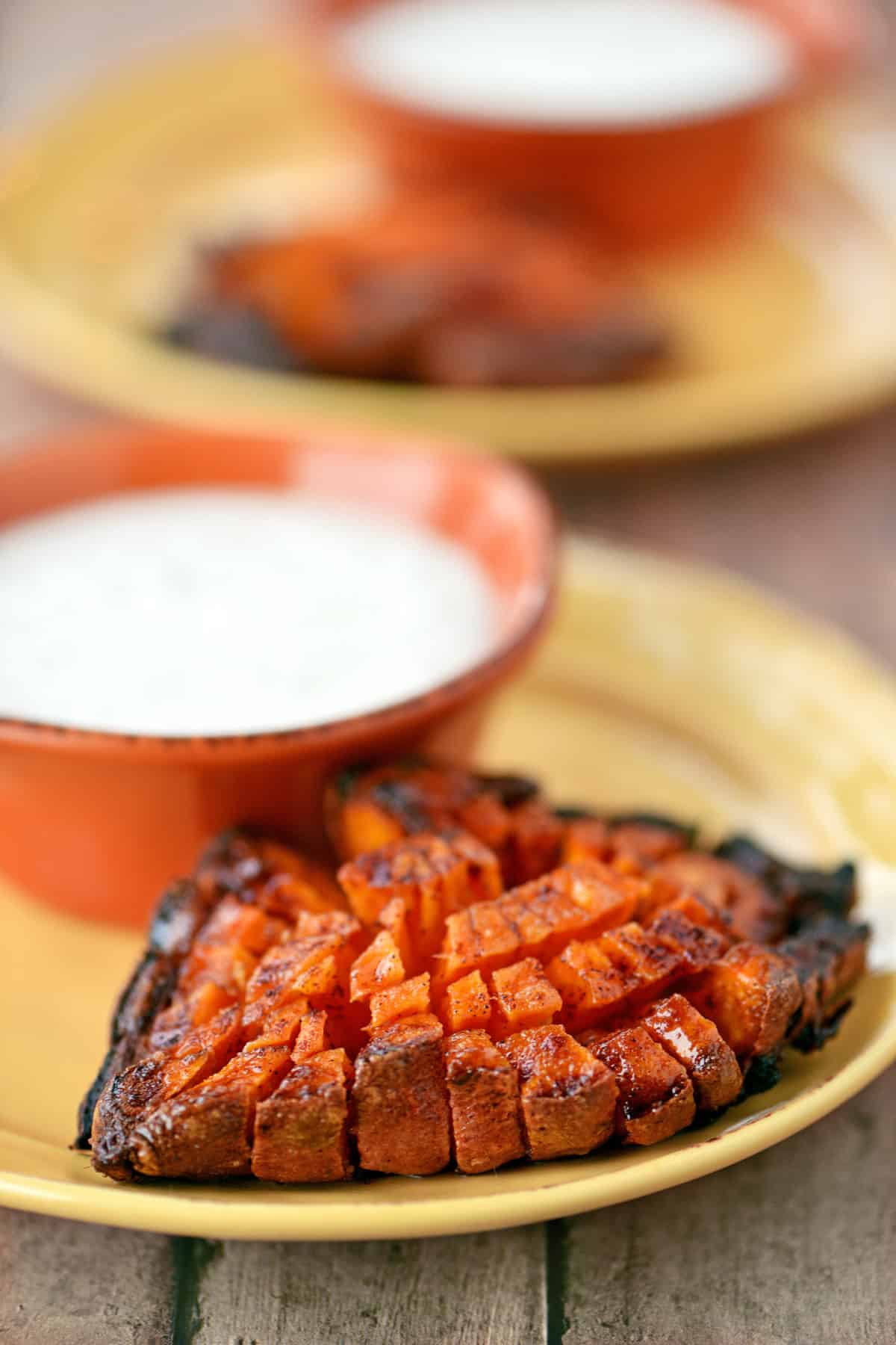 A bloomin sweet potato on a plate.