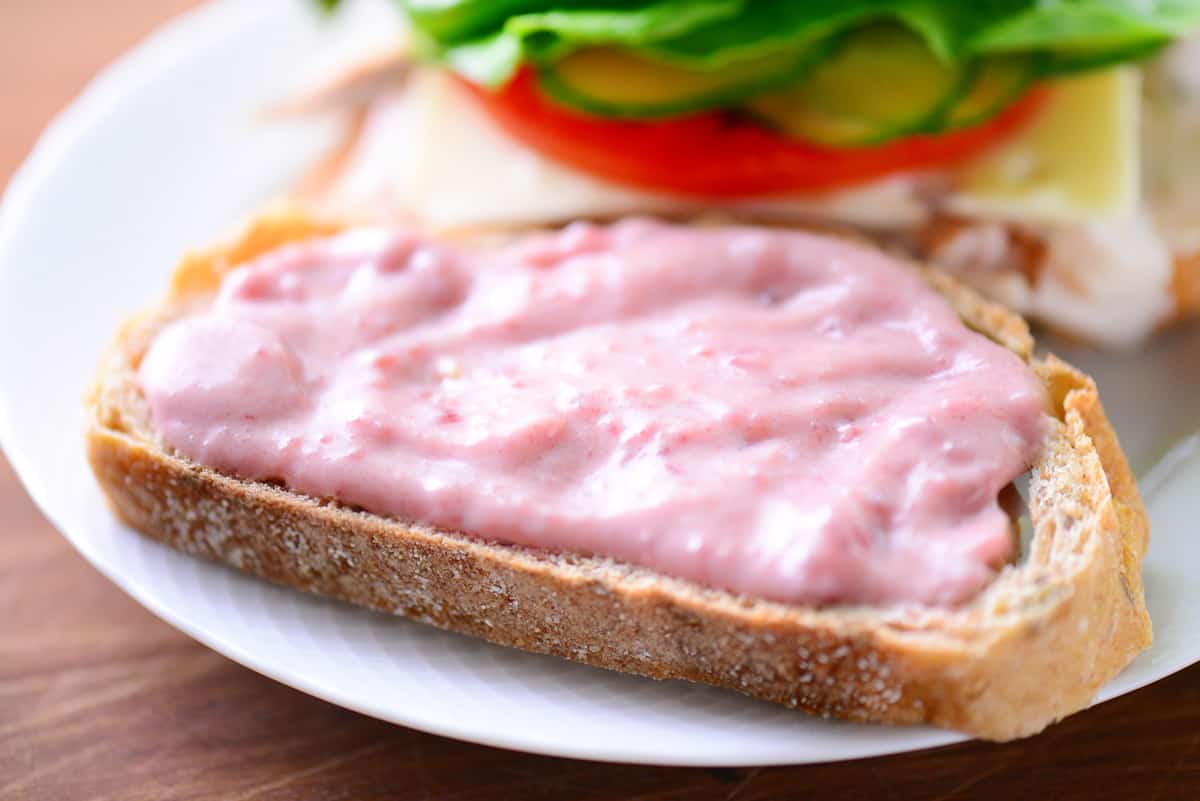 Cranberry mayo on a slice of bread.