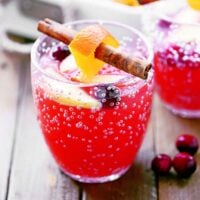 Cranberry orange Christmas punch in a clear glass.