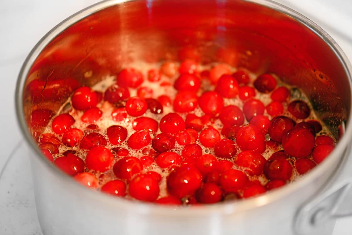 Cranberry sauce cooking in a pan.