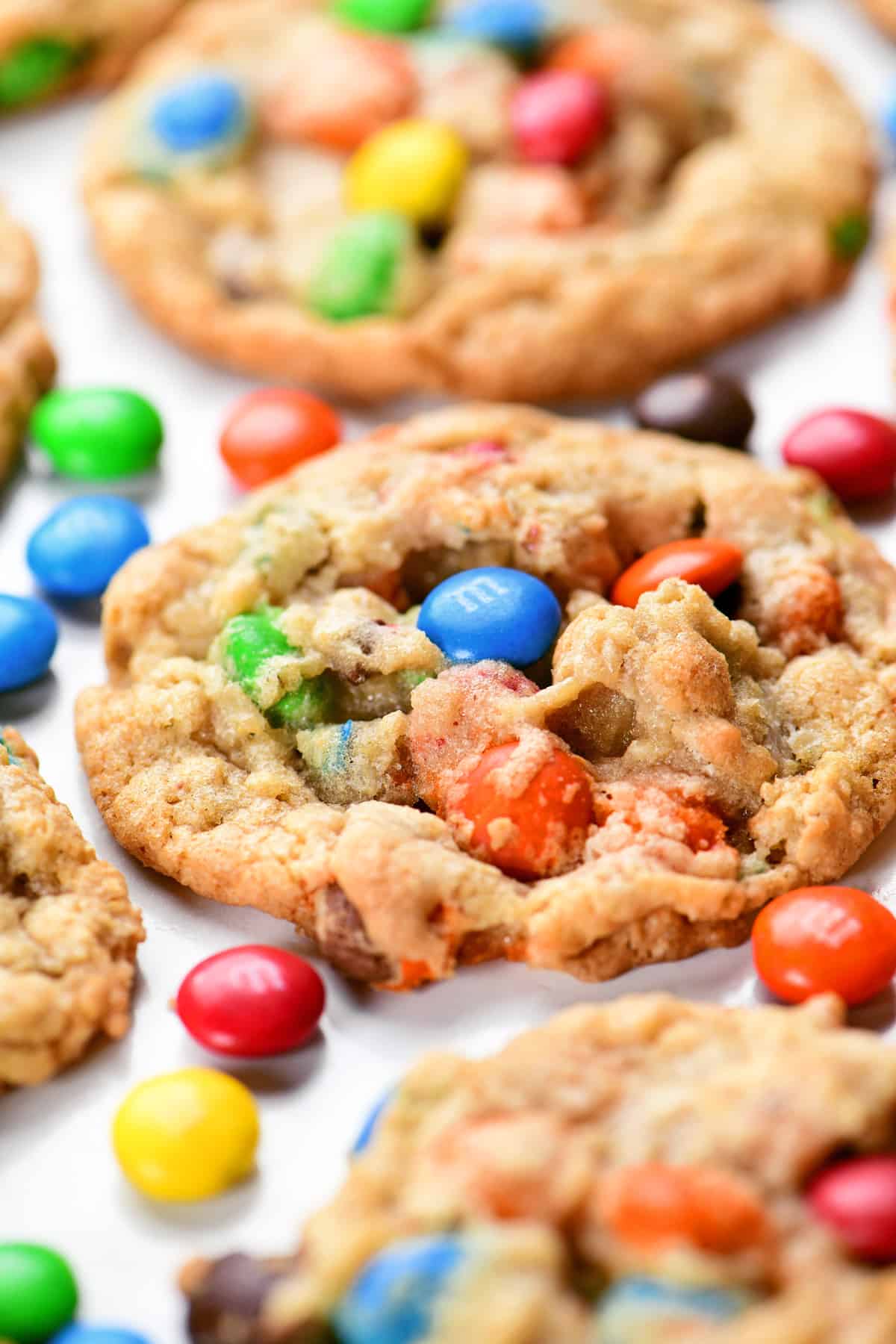 Oatmeal M&M cookies on a sheet of parchment paper.