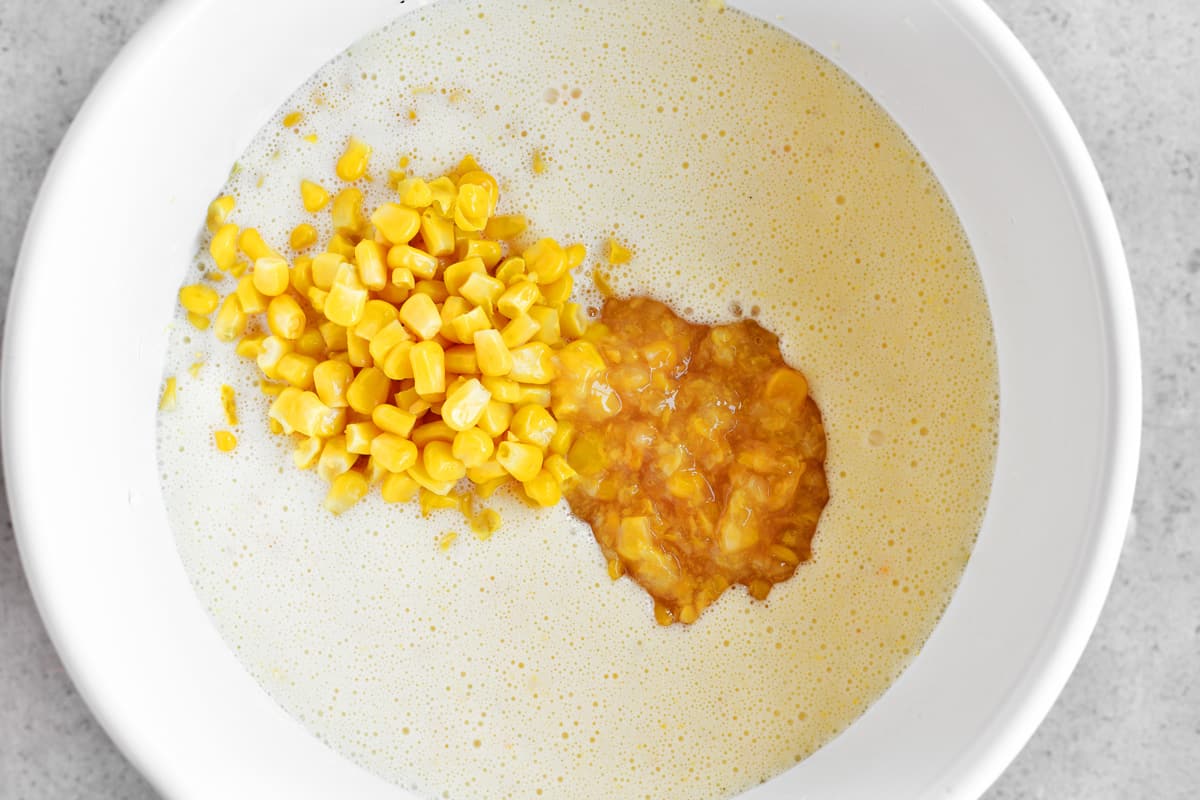 Sweet corn and creamy style corn added to bowl