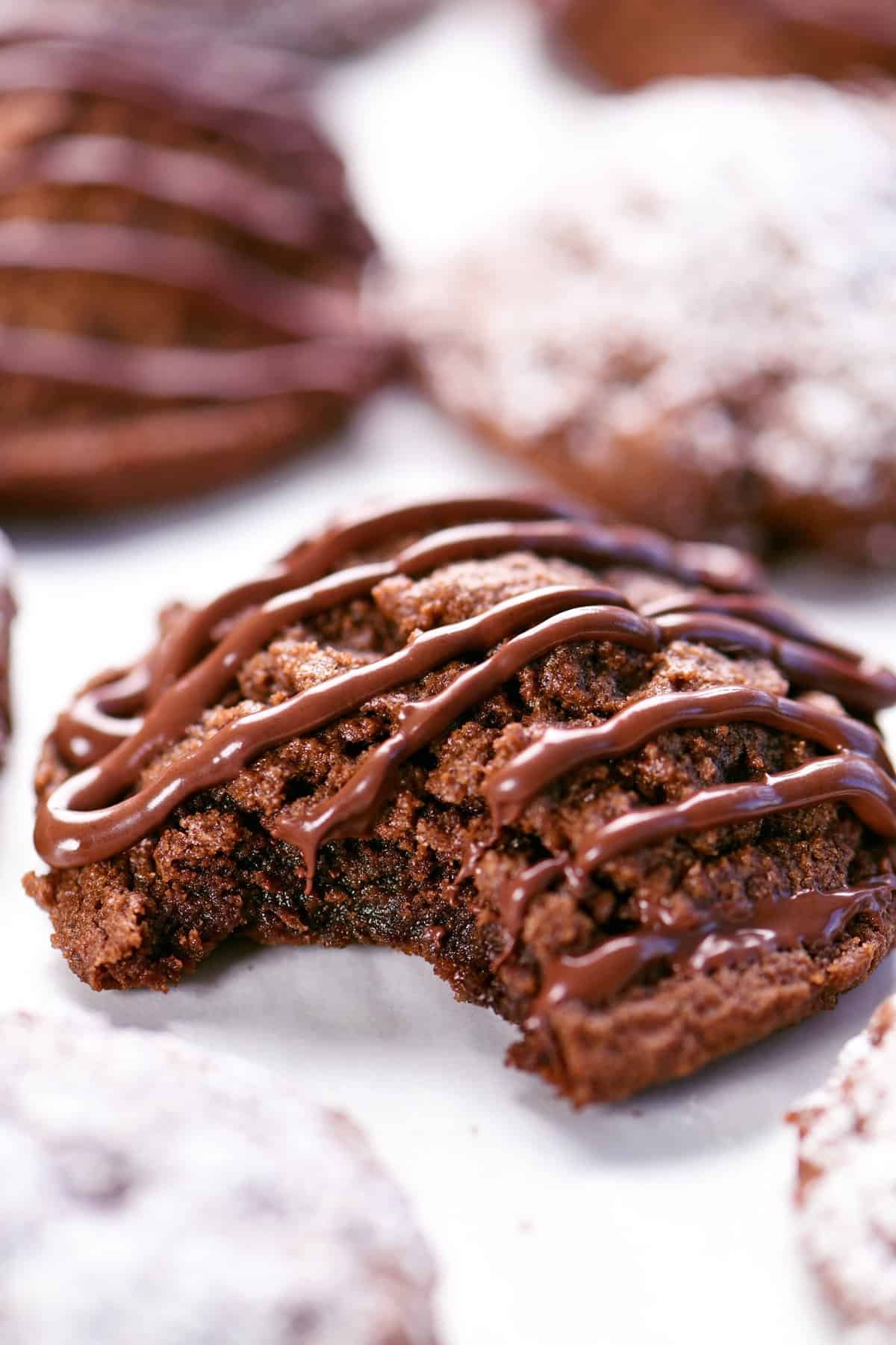 Triple chocolate cookies with a bite removed.