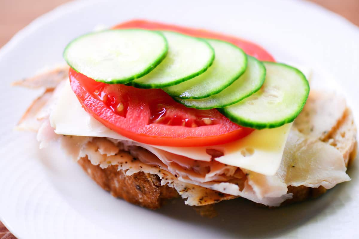 A slice of tomato and cucumber slice on top.