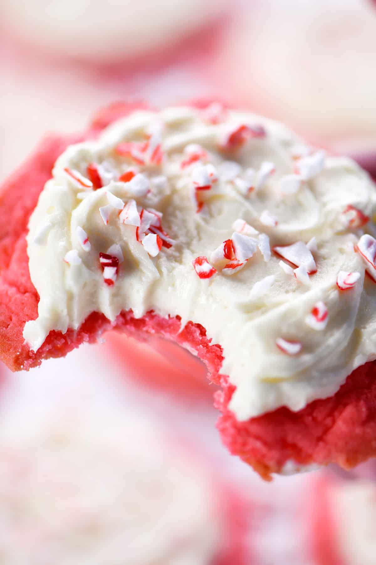 Peppermint cookies with buttercream frosting and crushed candy canes on top.