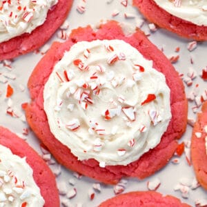 Peppermint cookies with buttercream frosting and crushed candy canes on top.