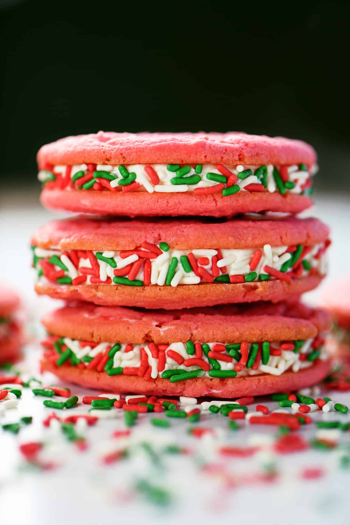 Peppermint sandwich cookies with red and green sprinkles.