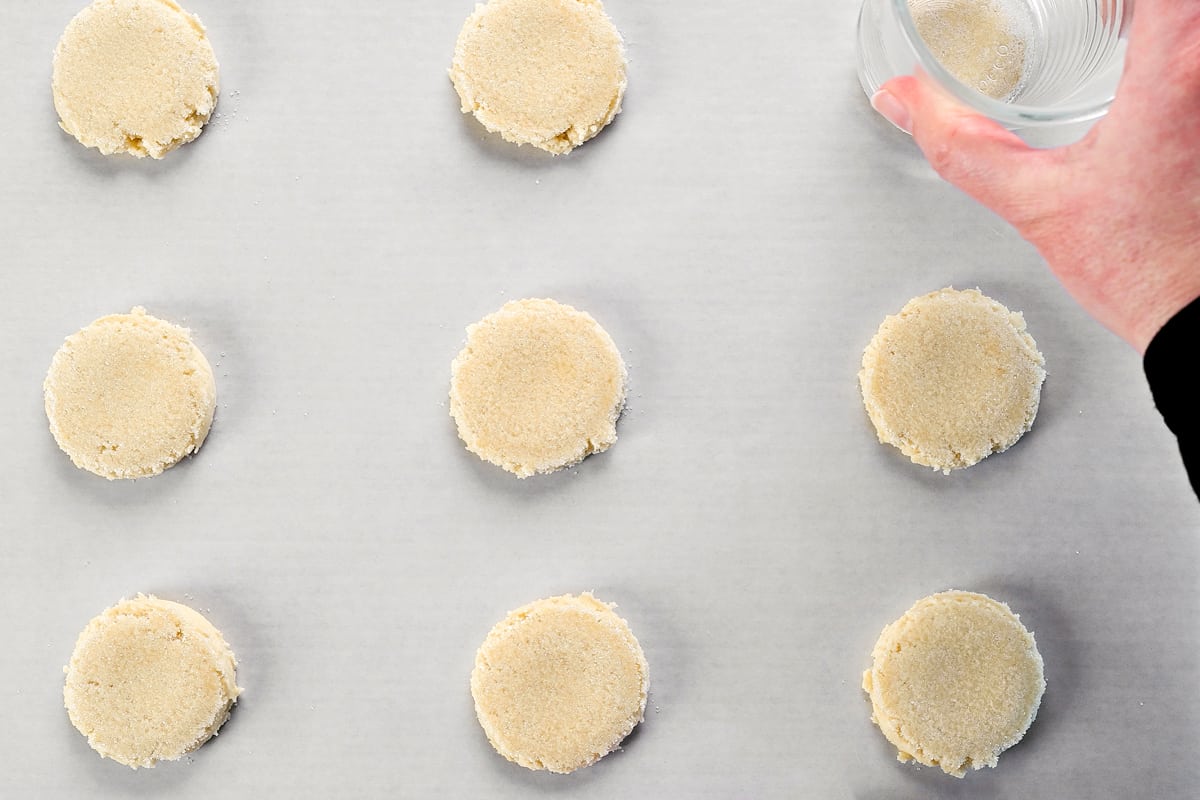 Use a glass to flatten the cookie dough balls.