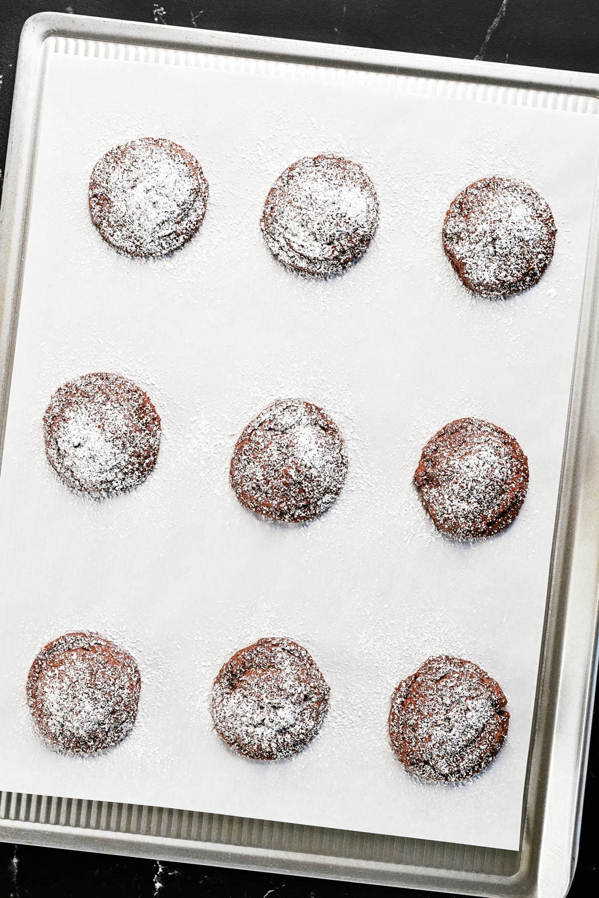 Triple chocolate cookies with powdered sugar on top.