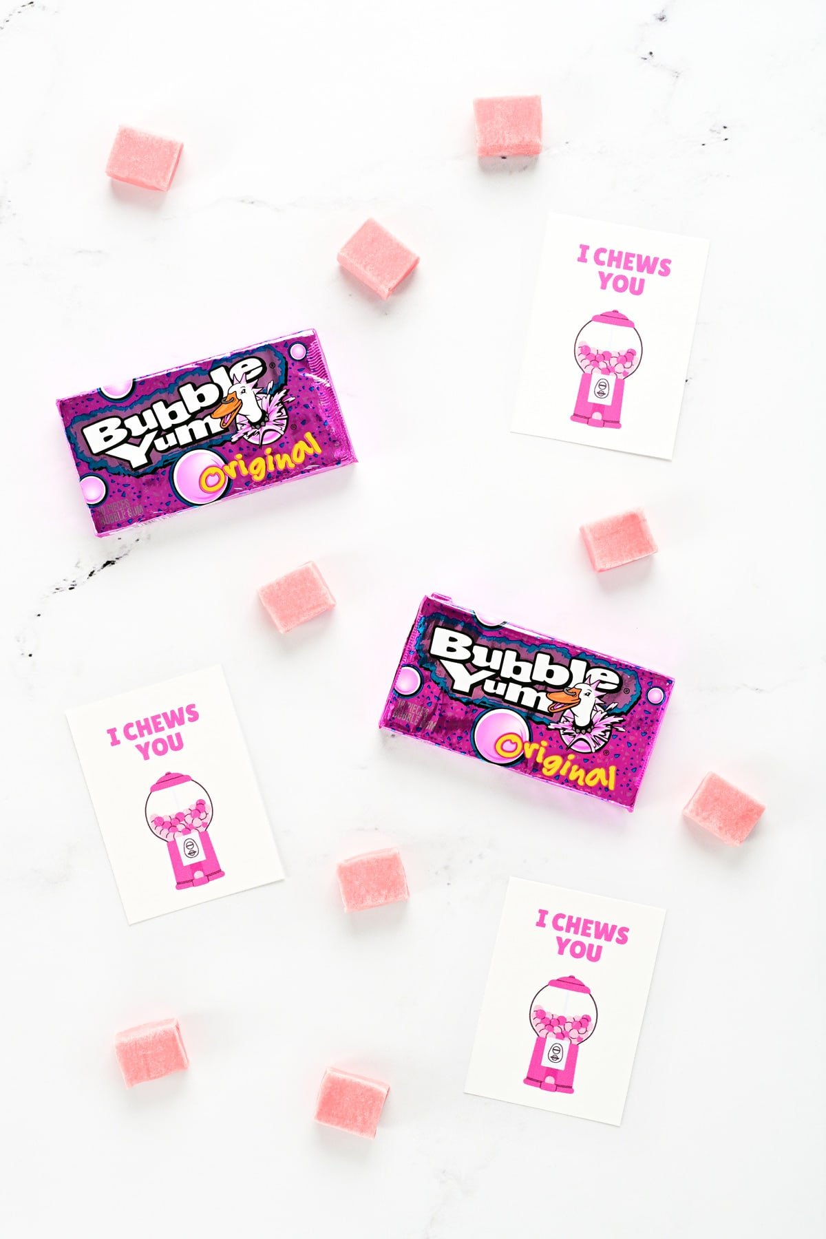 Bubble Yum bubblegum and free printable valentines for kids on a countertop.