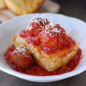 Baked spaghetti with meatballs on top.