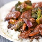 Beef and broccoli over rice in a bowl.