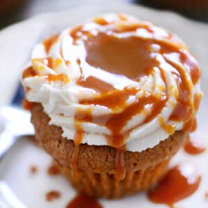 Caramel apple cupcake on a white plate.