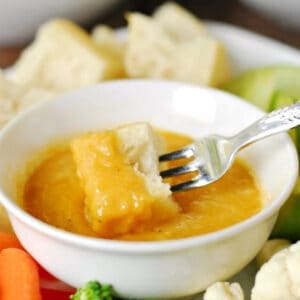 Cheese fondue in a white bowl.