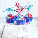 Fireworks cupcakes on a white cake stand.