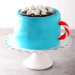 A cake that looks like a mug of hot chocolate.