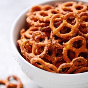 A bowl filled with mac and cheese flavored pretzels.