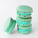 Mint macarons in a stack.