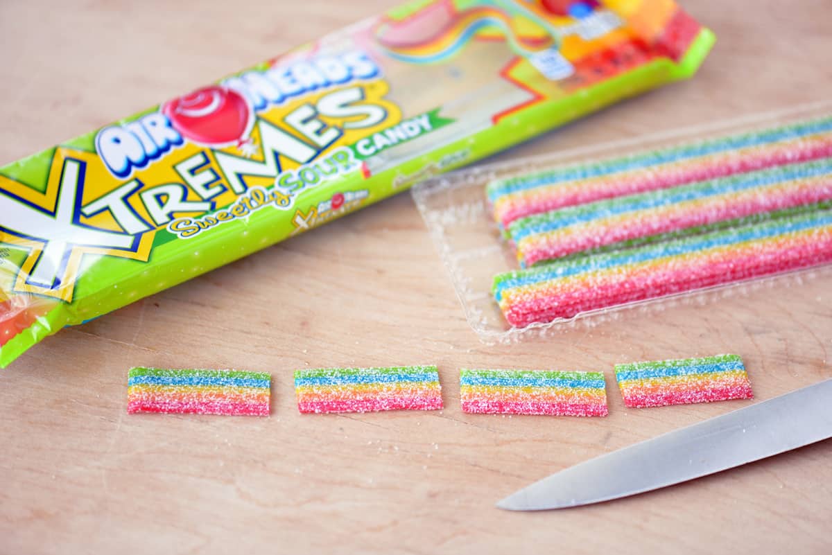 Cut rainbow candy into pieces.