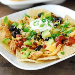 Slow cooker nacho bar on a white plate.