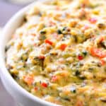Slow cooker spinach and artichoke dip in a bowl.