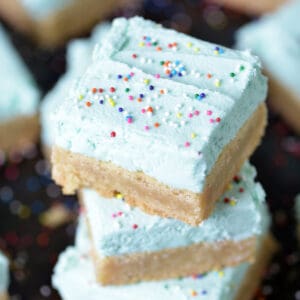 Stack of frosted brown butter sugar cookie bars.