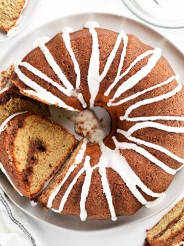 Top down view of a cinnamon Bundt cake and slices of the cake.