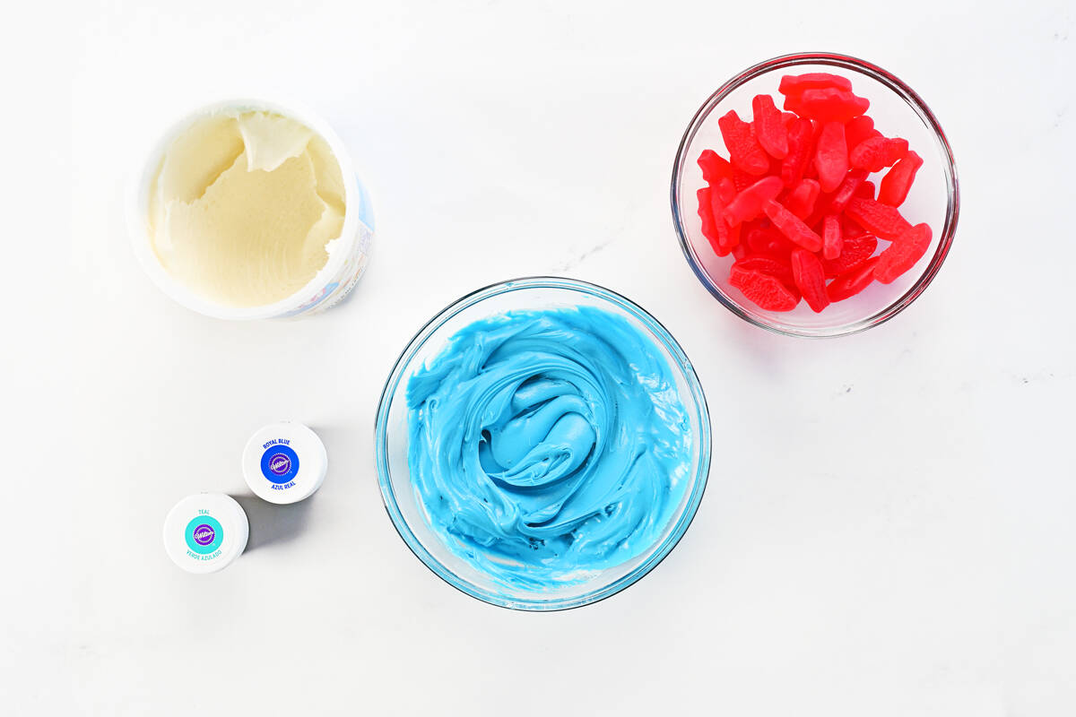 Frosting, food coloring, Swedish fish, and food coloring.
